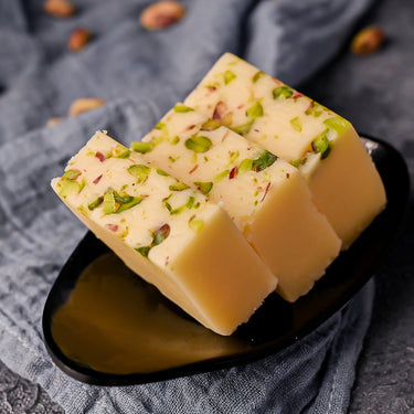 https://cdn.shopify.com/s/files/1/1857/6931/files/VellankiFoods-ButterBurfi2.jpg?v=1716901723